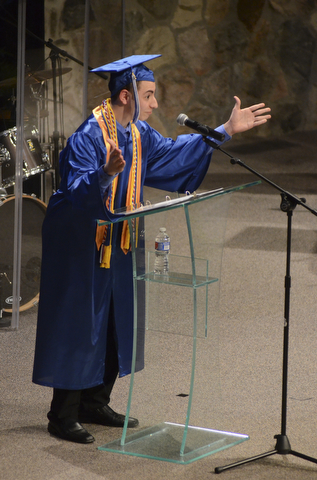 Katie Rickman | The Vindicator.Co-Valedictorian Vincent Talley puts his hands in the air while excitedly saying that the graduates had finally made it to graduation day during the Youngstown Christian School ceremony at Highway Tabernacle on May 31, 2015.