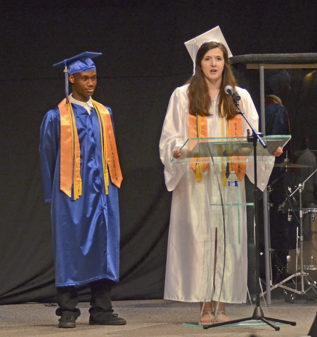 Katie Rickman | The Vindicator.Co-Salutatorian's Jordan Snipes, left, and Sarah Crouch stand at the podium to give a brief speech at the Youngstown Christian School graduation at Highway Tabernacle on May 31, 2015.