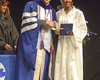 Katie Rickman | The Vindicator.Teraea  Mackenzie Devine Hennings shakes hands with Mike Pecchia as he received his diploma at Youngstown Christian School graduation at Highway Tabernacle on May 31, 2015.
