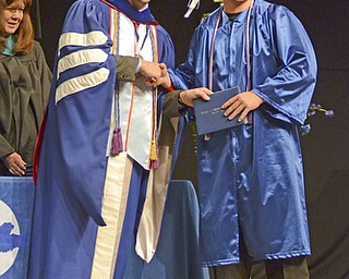Katie Rickman | The Vindicator.Nathanael Joseph Tayman shakes hands with Mike Pecchia during the Youngstown Christian School graduation at Highway Tabernacle on May 31, 2015.