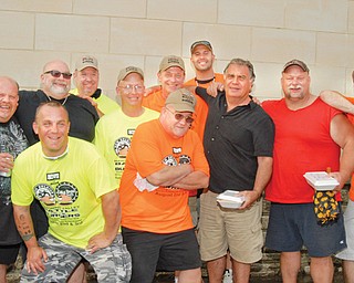The crew of the “Fat N’ Furious” television show and the Burger Guyz will team up Saturday for two events in downtown Youngstown: a car show and the Battle of the Burgers II. In the front row are Jim “Knuckles” Murphy and John Spatar (arms crossed). In back, from left, are Chuck Kountz and Tommy Christmas (from “Fat N’ Furious”), Scott Long, Anthony Fuda, JT, James Chizmark, Andy Pivarnik and Steve McGranahan (from “Fat N’ Furious”) and Eric Tranovich.