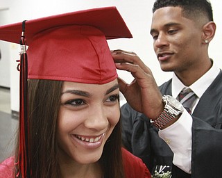 William D. Lewis The Vindicator  Campbell Memorial grad Tahlia Sandoval getsw some help with her cap from fellow grad Edgar Toledo before start of commencement ceremony 6-4-15 at Campbell HS.