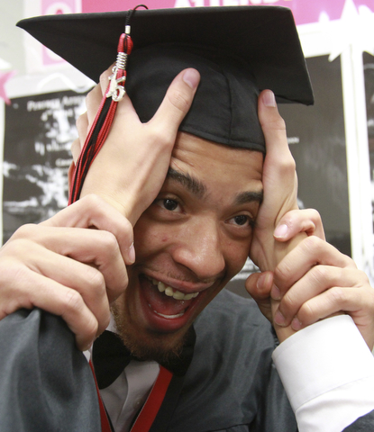 William D. Lewis The Vindicator  Campbell Memorial grad Nicholas Godoy gets some help with his cap from a  fellow grad  before start of commencement ceremony 6-4-15 at Campbell HS.
