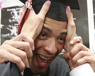 William D. Lewis The Vindicator  Campbell Memorial grad Nicholas Godoy gets some help with his cap from a  fellow grad  before start of commencement ceremony 6-4-15 at Campbell HS.