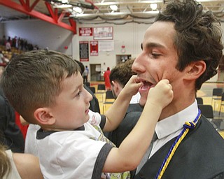 William D. Lewis The Vindicator  Campbell Memorial grad George Billiris shares a lighter moment withhis 3-year old cousin Christian Stamp after commencement ceremony 6-4-15 at Campbell HS.