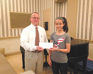 SPECIAL TO THE VINDICATOR
At its May 20 meeting, the Rotary Club of Youngstown honored Annabelle Day, the returning Vindicator Spelling Bee champion, and other local students. Paul Garchar, club president, presented her with a gift card to iTunes for her accomplishment. Annabelle is an eighth-grader at Willow Creek Learning Center in Boardman.
