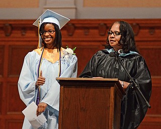 Katie Rickman | The Vindicator.Shelby Johnson give the thumbs up before receiving a special recognition and gift from senior advisor Kaylor White during the commencement ceremony at Stambaugh Auditorium on June 5, 2015.