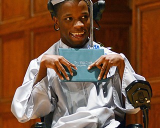Katie Rickman | The Vindicator.Terrence Rankin smiles as he holds up his diploma after the East High School commencement ceremony at Stambaugh Auditorium on June 5, 2015.