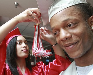 William D. Lewis The vindicator Isaiah Randall gets some help with his graduation cap from fello Chaney grad Ashley Delgado before start of Chaney commencement Friday 6-5-15.06052015 wdl chaney a..