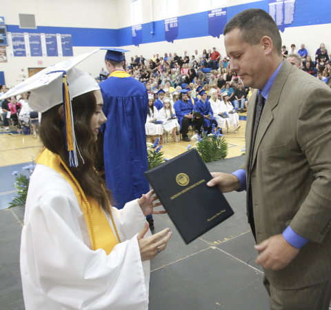William D. Lewis The Vindicator  Jackson Milton HS principal Davud Vega presents diploma to his daughter Jacqueline Vega during Friday ceremony. she was  1 of 8 valedictorians.