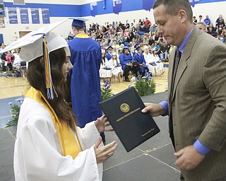 William D. Lewis The Vindicator  Jackson Milton HS principal Davud Vega presents diploma to his daughter Jacqueline Vega during Friday ceremony. she was  1 of 8 valedictorians.