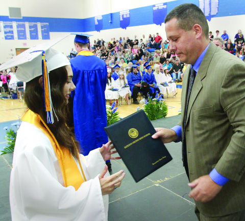 William D. Lewis The Vindicator  Jackson Milton HS principal Davud Vega presents diploma to his daughter Jacqueline Vega during Friday ceremony. she was  1 of 8 valedictorians.