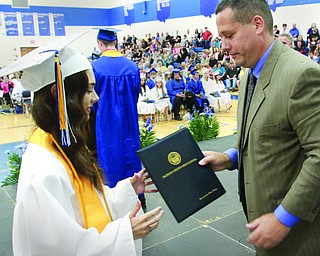 William D. Lewis The Vindicator  Jackson Milton HS principal Davud Vega presents diploma to his daughter Jacqueline Vega during Friday ceremony. she was  1 of 8 valedictorians.