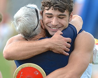 Jeff Lange | The Vindicator  JUNE 5, 2015 - McDonald senior Christian Smith embraces his grandfather Bill Smith after being named state champion in the boys discus event in Columbus. Christian's won with a throw of 191 feet 2 inches.