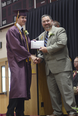 Katie Rickman | The Vindicator.Andrew Thomas Cullar smiles as Board of Education President Ralph Wince hands him his diploma South Range High School on June 6, 2015.