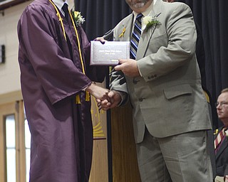 Katie Rickman | The Vindicator.Andrew Thomas Cullar smiles as Board of Education President Ralph Wince hands him his diploma South Range High School on June 6, 2015.