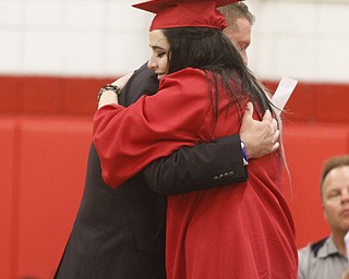       .         ROBERT  K. YOSAY | THE VINDICATOR..Bailey Hefner Presented Principal Christopher Berni a gift from the graduating CLASS of 2015.. Over 300 Austintown Fitch graduates received their diplomas at Saturday Morning commencement in the High School Gym..-30-