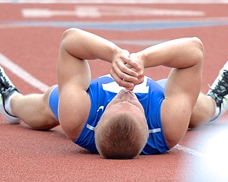 Jeff Lange | The Vindicator  JUNE 6, 2015 - Warren JFK senior Chad Zallow lies down in pain after completing the 300 meter hurdle event during the 2015 state track and field tournament held at Jesse Owens Memorial Stadium in Columbus, Saturday. Zallow still finished first in the event.