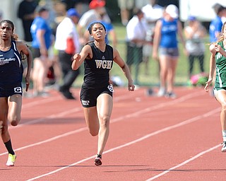 Jeff Lange | The Vindicator  JUNE 6, 2015 - Warren Harding's Justice Richardson (center) sprints down the track with Twinsburg's Emmarie Foote (left) and Coffman's Abby Steiner in the 100 meter dash during Saturday's 2015 state track and field tournament held at Jesse Owens Memorial Stadium in Columbus.