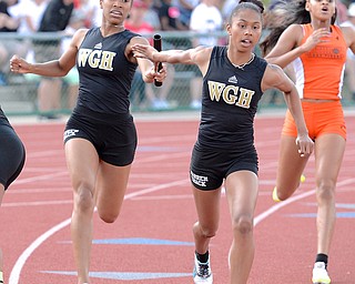 Jeff Lange | The Vindicator  JUNE 6, 2015 - Warren G.Harding's Gariana Bercheni (left) makes the handoff to Ka'Naylah Cox in the girls 4x200 meter relay during Saturday's 2015 state track and field tournament held at Jesse Owens Memorial Stadium in Columbus.