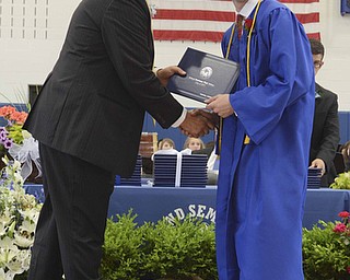 Katie Rickman | The Vindicator.Mitchell Franko, on right, shakes hands with Dr. Larry Dinopoulas, a Poland Board Member, after receiving his diploma at Poland High School commencement on Sunday June 7, 2015.