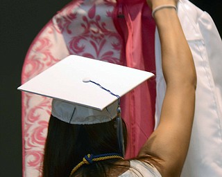 Katie Rickman | The Vindicator.Elise DeMartino removes clothing from a garment bag as she and fellow graduates prepared to graduate from Poland High School on Sunday June 7, 2015.