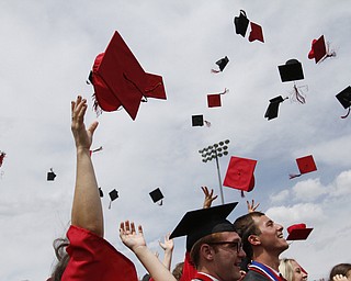       .         ROBERT  K. YOSAY | THE VINDICATOR..Hats fly as the graduates finish the ceremony..Canfield High School Graduation on the football field in Canfield..-30-