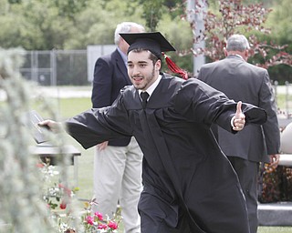       .         ROBERT  K. YOSAY | THE VINDICATOR..Neal Timlin class president - runs for a  chest bump after receiving his diploma..Canfield High School Graduation on the football field in Canfield..-30-