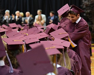BOARDMAN, OHIO - JUNE 7, 2015: William Zupko gets a hug from friend and fellow classmate Anthony Pallante after receiving his diploma during the Boardman High School commencement ceremony Sunday Afternoon at Boardman High School. (Photo by David Dermer/Youngstown Vindicator)