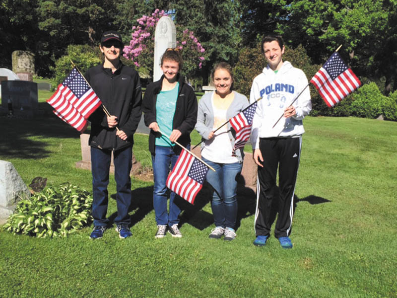SPECIAL TO THE VINDICATOR
Holy Family Youth Ministry of Holy Family Church in Poland recently helped the Boy Scouts place flags at the graves of military veterans at Poland Riverside Cemetery. From left are Mark Stein, Maria LoCicero, Angelina Sabatino and Noah Landry.