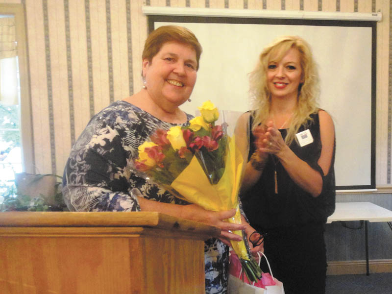 SPECIAL TO THE VINDICATOR
Kathleen Dragoman, left, outgoing president, accepts flowers from Michele McBride Simonelli, the new president of the League of Women Voters of Greater Youngstown. Other new officers are Anne Harpman, first vice president; Janet Chittock, second vice president; Dorothy Kane, secretary; and Dana Cina, treasurer. Directors are Gwen Fish, Nancy Terlesky, Nancy Newton, Corlis Green and Sarah Lowry.