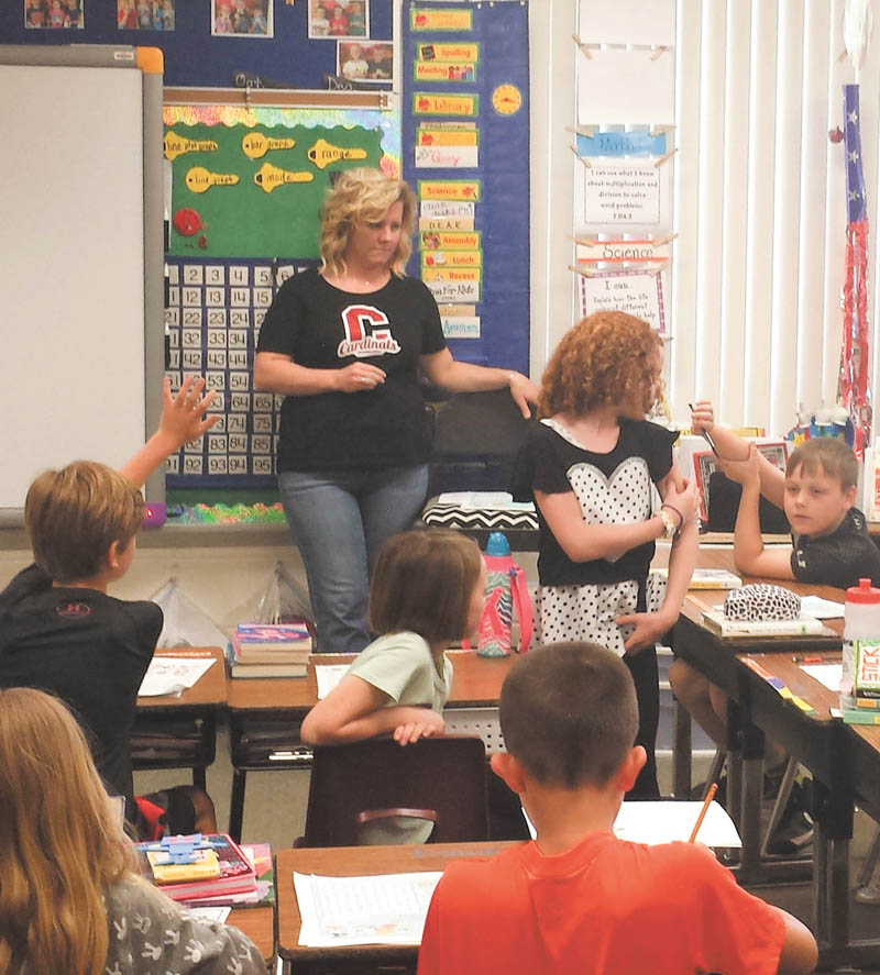 SPECIAL TO THE VINDICATOR
Marguerite Hassay of Diabetes Partnership of Mahoning Valley recently presented a video to Canfield Hilltop Elementary students, which explains that children can still live out their goals and dreams even with the disease. Third-grade student Ava Littler demonstrated her glucometer, which determines the approximate concentration of glucose in the blood, to her classmates and answered questions. Standing with her is her teacher, Alexis Novotny, who welcomed the educational event. The DPMV will have a booth in the Medical Building at the Canfield Fair.
