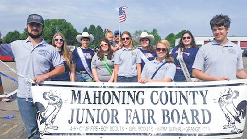SPECIAL TO THE VINDICATOR
Youths and advisers from the Mahoning County Junior Fair Board marched in the Boardman Memorial Day Parade in memory of past adviser George Grim. Holding the sign are, from left, Solomon Driscoll, Karlee Banks and Tyler Moff. Behind them are Sarah Mendenhall; Joe Fagnano, 2015 Mahoning County Outstanding Youth; Angell Benson; Carley Zilany; Logan Moff, 2015 Mahoning County Outstanding Youth; and Dani Yuhas. In back holding the flag are Macie Vernon and Kyle Vernon. Kim Moff is the junior fair manager.