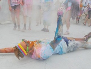 Jeff Lange | The Vindicator  JUNE 13, 2015 - An exhausted runner rolls on the ground after finishing the 2015 Youngstown Color Run, Saturday morning.