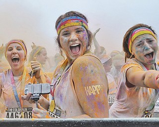 Jeff Lange | The Vindicator  JUNE 13, 2015 - Three young runners pose for a photo during the dance party after the Color Run in Youngstown, Saturday morning.
