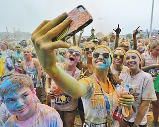 Jeff Lange | The Vindicator  JUNE 13, 2015 - A group of participants pose for a "selfie" during the dance party after completing the Color Run 5K race, Saturday morning. Thousands of runners from neighboring areas gathered at the Covelli Centre for the 2015 Color Race in Youngstown.
