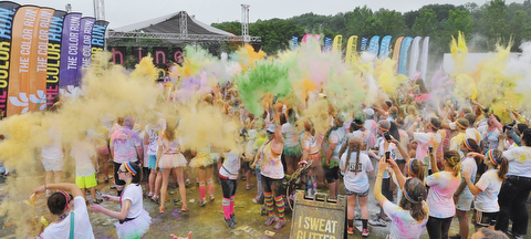 Jeff Lange | The Vindicator  JUNE 13, 2015 - Participants gather to dance and throw colored powder in the air after completing the Color Run 5K race, Saturday morning. Thousands of runners from neighboring areas gathered at the Covelli Centre for the 2015 Color Race in Youngstown.