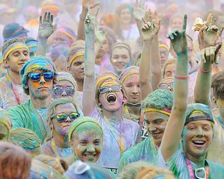Jeff Lange | The Vindicator  JUNE 13, 2015 - Participants gather to dance and throw colored powder in the air after completing the Color Run 5K race, Saturday morning. Thousands of runners from neighboring areas gathered at the Covelli Centre for the 2015 Color Race in Youngstown.