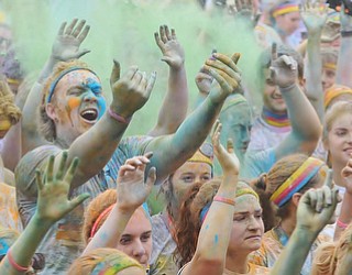 Jeff Lange | The Vindicator  JUNE 13, 2015 - McDonald High School senior Matt Howard (left center) screams and dances with other runners of the 2015 Color Run in Youngstown, Saturday afternoon.