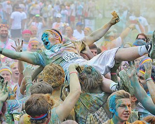 Jeff Lange | The Vindicator  JUNE 13, 2015 - A participant of the 2015 Color Run crowd surfs after running the race, Saturday afternoon at the Covelli Centre in Youngstown.