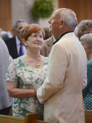 Katie Rickman | The Vindicator.Annette Weidner smiles up at her husband Ralph after renewing their vows after 56 years of marriage during the Wedding Anniversary Mass at St. Columba Cathedral in Youngstown.
