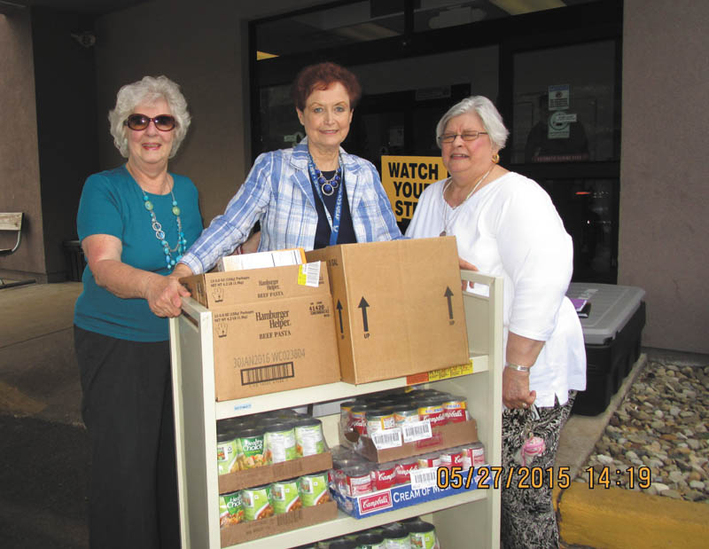 SPECIAL TO THE VINDICATOR
The Mahoning Chapter of the Daughters of the American Revolution recently donated food items, bus passes and gift cards to the Youngstown branch of U.S. Department of Veterans Affairs. Funds came from the proceeds made at a Gift-A-Rama. Above from left are Mildred Lumley, DAR regent; Laurie Stone, VA volunteer coordinator; and Barbara Parker, DAR chapter veteran committee chairwoman. Dr. Robert Marcus is the local VA Homeless Outreach Coordinator.
