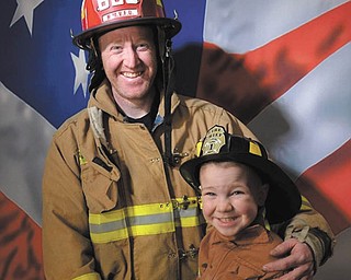 Michael Riley and his son, Liam, both of New Middletown, are dressed like twins. Liam is so glad that his dad has raised him to be just like him when he grows up. His dad is a firefighter who saves lives and helps in any way he can. Liam is fascinated with firefighters, fire trucks, and everything they do. His dad is his true hero.