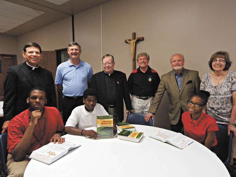 SPECIAL TO THE VINDICATOR
Members of the Men’s Renewal Group of St. Michael Parish donated funds to St. Joseph the Provider School in Youngstown. The money was for copies of the African American Catholic Youth Bible for middle school students. It contains commentaries, footnotes and artwork to help black students understand Scripture and the role of Jesus in their lives. Seated, from left, are students Jalen Adams, Jarail Jenkins and Desirae Hairston. Standing are the Rev. Michael Swierz, president of St. Joseph the Provider School; Alan Ricks, board member of the school and a St. Michael’s parishioner; the Rev. Terry Hazel, St. Michael’s pastor; Miros Maszczak and Charles Wirtz, parishioners at St. Michael’s; and Cheryl Jablonski, school principal.