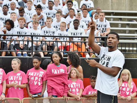 Jeff Lange | The Vindicator  JUNE 20, 2015 - Brad Smith (right) Chaney grad and current free agent in the NFL introduces the children to the coaches prior to the start of his 8th annual football camp held at Stambaugh Stadium in Youngstown.
