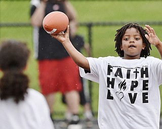 Jeff Lange | The Vindicator  JUNE 20, 2015 - 8 year old Noah Thomas of Austintown (right) looks to make a pass to another child during quarterback drills at Saturday's 8th annual Brad Smith football camp held at Stambaugh Stadium in Youngstown.