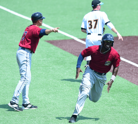 MORGANTOWN, WEST VIRGINIA - JUNE 21, 2015: D'vone McClure #1 of the Scrappers is waived home to score a run by manger Travis Fryman in the top of the 4th inning during game one of Sunday afternoons double header at game at Monongalia County Ballpark. DAVID DERMER | THE VINDICATOR