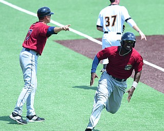 MORGANTOWN, WEST VIRGINIA - JUNE 21, 2015: D'vone McClure #1 of the Scrappers is waived home to score a run by manger Travis Fryman in the top of the 4th inning during game one of Sunday afternoons double header at game at Monongalia County Ballpark. DAVID DERMER | THE VINDICATOR