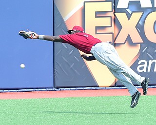 MORGANTOWN, WEST VIRGINIA - JUNE 21, 2015: Left fielder D'vone McClure #1 of the Scrappers flies through the air after diving to unsuccessfully catch the baseball in the bottom of the 7th inning during game one of Sunday afternoons double header at game at Monongalia County Ballpark. DAVID DERMER | THE VINDICATOR