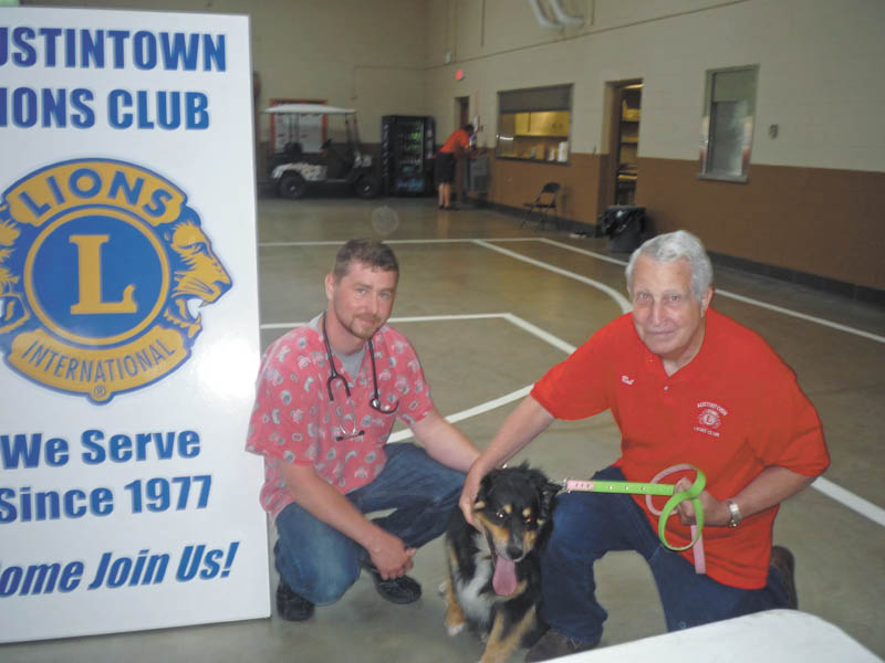 SPECIAL TO THE VINDICATOR
The Austintown Lions Club conducted its second annual Rabies Vaccination Clinic on June 13. Dr. Erik Dougherty of Sunny Ridge Veterinary Services gave the vaccinations. Lions Bob Whited and John Facemyer were the event chairmen. Above are Dr. Dougherty with Lion Bob Melcher and Bruno, the dog of a local resident.